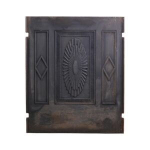 Antique Federal black cast iron fireplace fire back with a central sunburst relief, flanked by narrow side panels and visible wear along the edges.