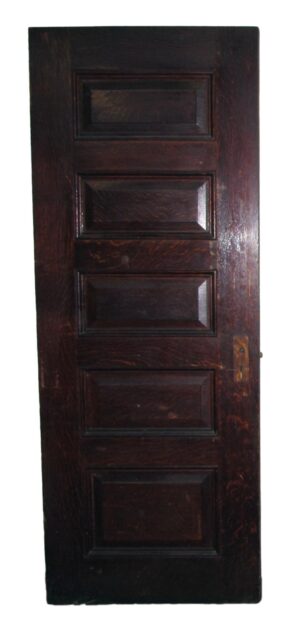 Dark wood tone interior door with five horizontal raised panels and a latch opening on the right side.