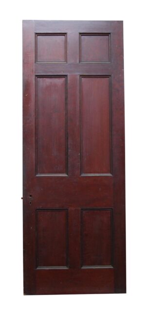 Six-panel door in a dark wood tone with a cherry composition and visible hardware openings on the left side.