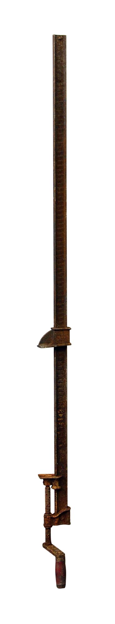 Antique cast iron bar clamp shown vertically with a long threaded screw and wooden handle.