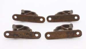Set of four cast iron window hinges with rusted black finish, shown as two paired hardware pieces in a close-up view.