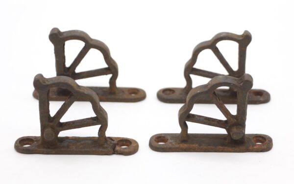 Set of four cast iron window hinge parts with a short base and staggered holes, shown in two pairs from above and at an angle.
