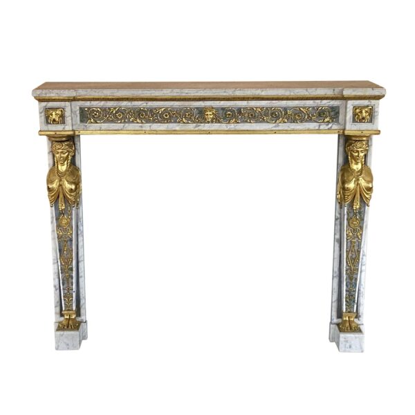 French Empire marble mantel with gray veining, gilt bronze female busts, and ornate scrollwork across the frieze and legs.
