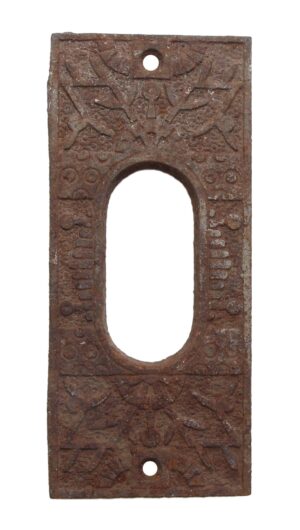 Cast iron pocket door plate in the Windsor pattern with an elongated center cutout and two screw holes, shown front on with a rusted patina and worn decorative detailing.