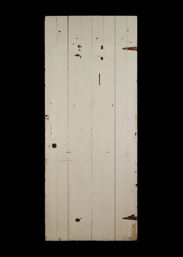 Antique four-board passage door painted white, shown front-on with visible paint wear and missing hardware holes.