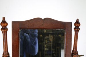 Victorian cherry wood shaving stand with an angular square mirror and turned side posts, shown in a close-up of the upper section.