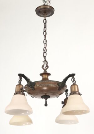 Colonial Revival four-arm chandelier with a brass pan body, black curved arms, and frosted white shades hanging from a chain.