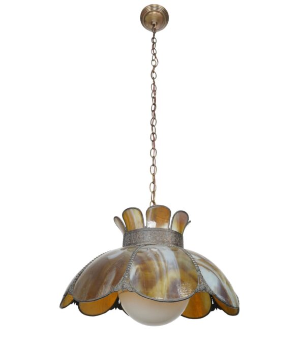 Art Nouveau stained glass pendant light with a scalloped amber, orange, and white shade, brass chain and canopy, and a white globe below.