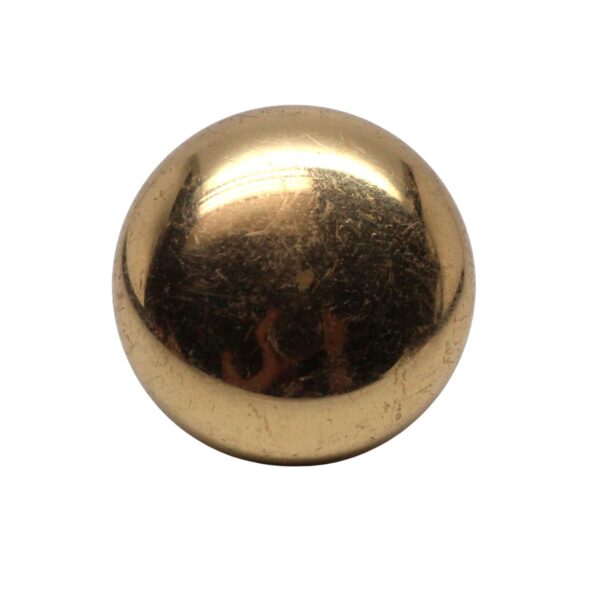 Round polished brass cabinet knob with a domed face and visible wear from age.