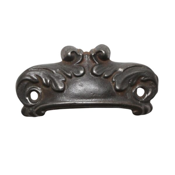 Traditional cast iron bin pull with decorative scroll details and two mounting holes.