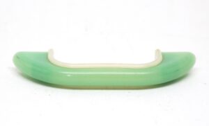Mid Century bridge drawer pull in green and white plastic, shown in a side view with a curved profile and mounting tabs at both ends.
