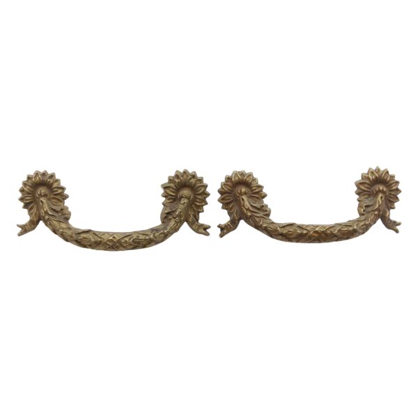 Pair of brass bridge drawer pulls with a Victorian floral swag design and antique patina, shown as a matching pair.