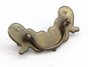 Traditional bail drawer pull in an antique brass finish, shown from the front with both mounting plates and the curved handle visible.