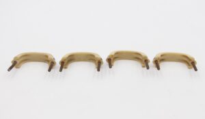 Set of four mid century drawer pulls with curved cream plastic handles and mounting screws attached.