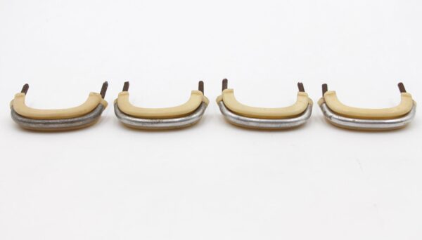 Set of four mid century drawer pulls with ivory plastic grips and nickeled brass bases, shown with mounting screws included.