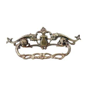 Ornate Victorian-style brass dresser bail pull with a cutout design and aged antique brass finish.