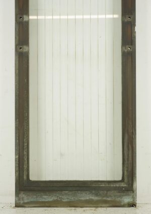 Art Deco commercial door with a full etched striped glass panel and bronze frame, shown front on with visible surface wear and steel hinge pockets on both sides.