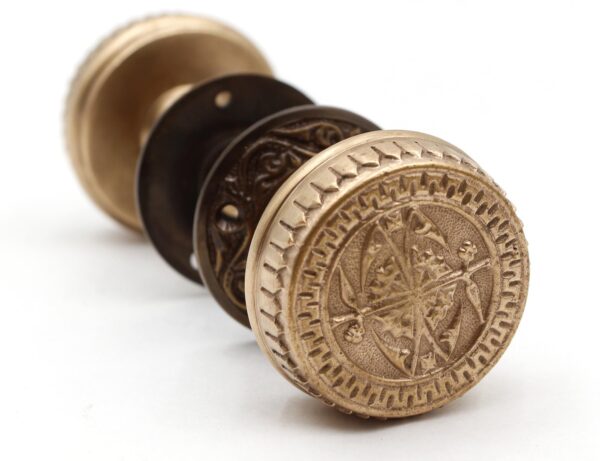 Front view of Brass Vernacular Passage Door Knob with ornate compass design, inspired by 1880s Branford styles.