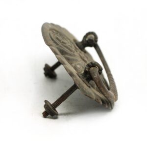 Victorian brass drawer bail pull with an antique patina, shown in a close-up angled view with mounting screws visible.