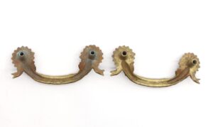Pair of Victorian brass bridge drawer pulls with floral ends and an antique patina, shown as a pair.