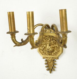 1920s Regency brass wall sconce with three candle arms and a lion head motif.