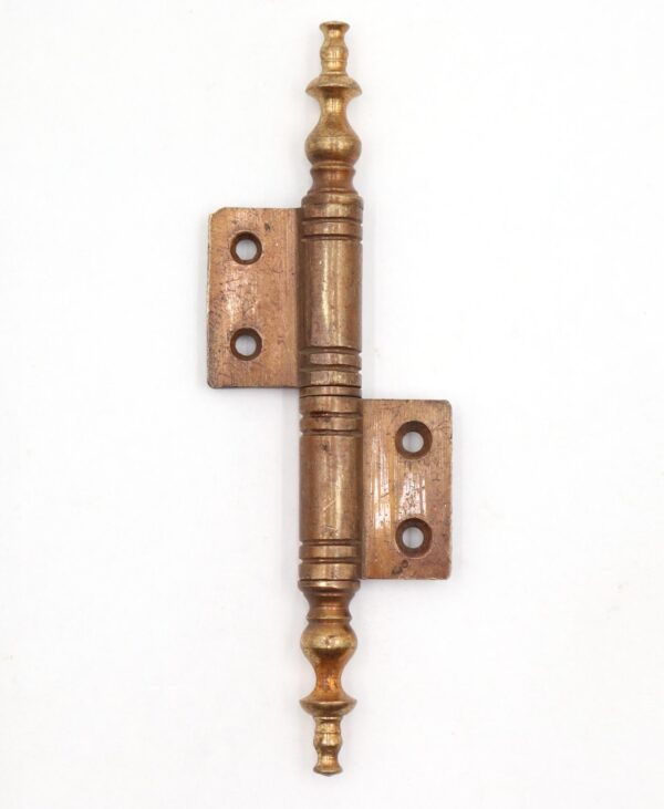Vintage brass right flag cabinet door hinge with steeple tips and two knuckles, shown in a straight-on view.