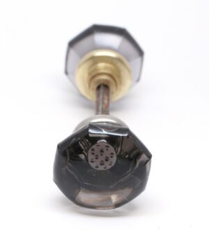 Pair of vintage glass door knobs with octagon-shaped purple knobs, nickel-plated and polished brass shanks, shown in a close-up front view.