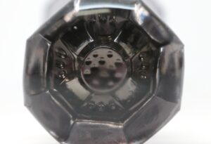 Close-up of an octagonal glass door knob with a controlled bubble center and visible metal shank details.