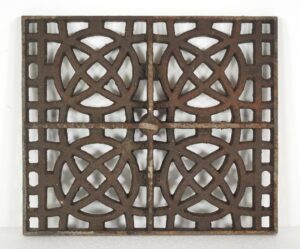 Rectangular cast iron grill cover with a geometric pattern and center ring pull.
