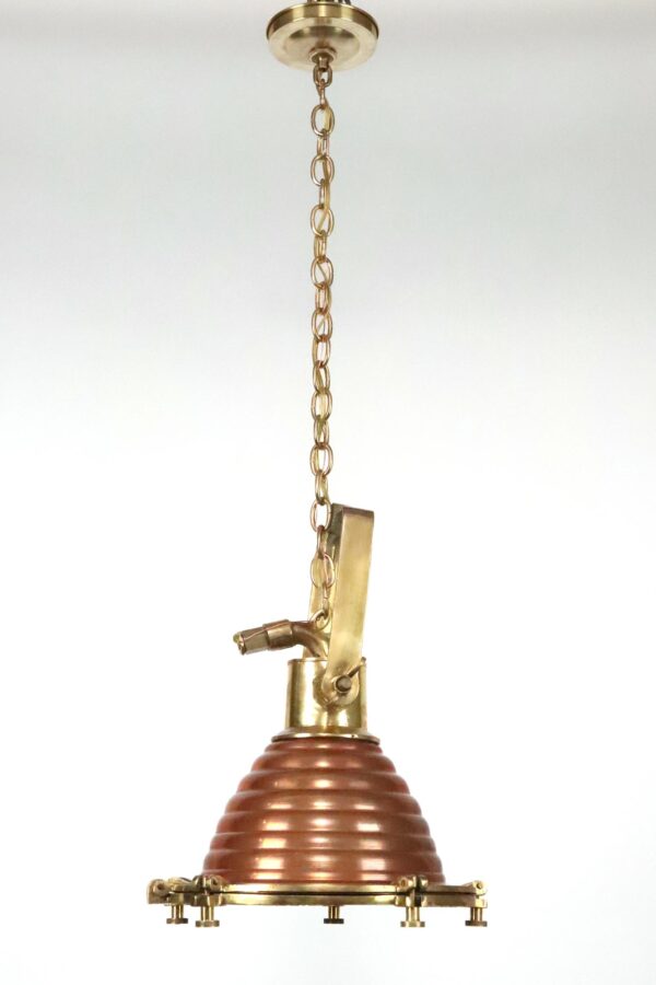Nautical pendant light with a chain-hung brass canopy, copper beehive shade, and brass spotlight hardware.