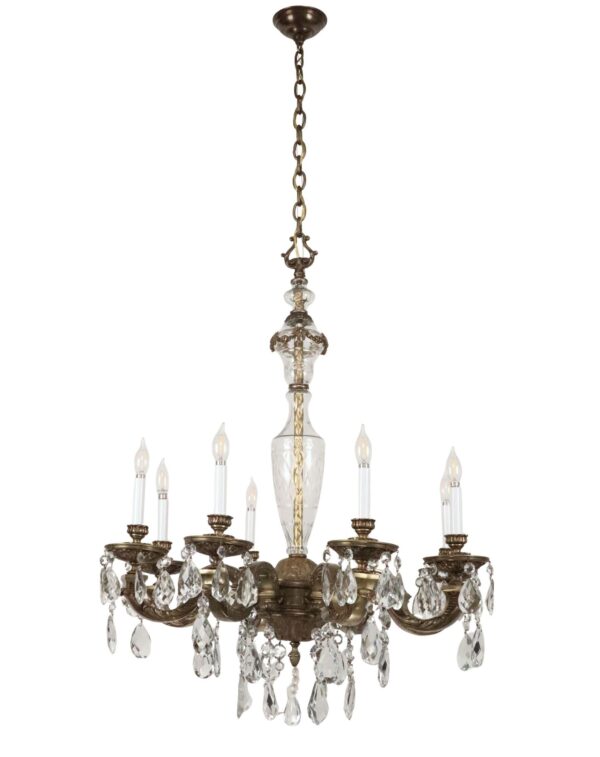 Victorian-style crystal and bronze chandelier with eight candle-style lights and hanging crystal prisms.
