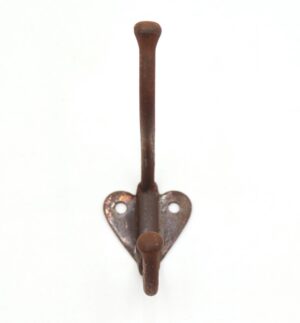 Vintage cast iron wall hook with two arms and a heart-shaped mounting plate, shown front on with surface wear and no screws included.