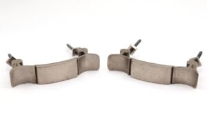 Pair of vintage drawer pulls in brushed nickel brass, shown as a pair with original mounting nuts attached.