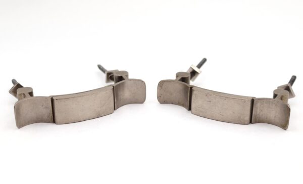 Pair of vintage drawer pulls in brushed nickel brass, shown as a pair with original mounting nuts attached.