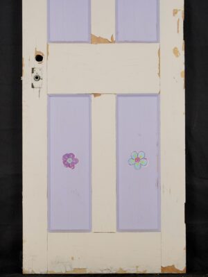 Six-panel privacy door painted white and purple, shown front view with a hole for a privacy latch, original brass hardware, and visible chipped paint and surface wear.