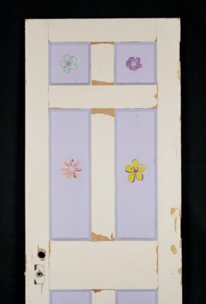 Six-panel privacy door painted white and purple, shown front on with a privacy latch hole and visible surface wear, chipped paint, and attached brass hardware.