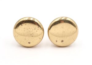 Pair of polished brass cabinet knobs shown side by side, each round and slightly worn from prior use.