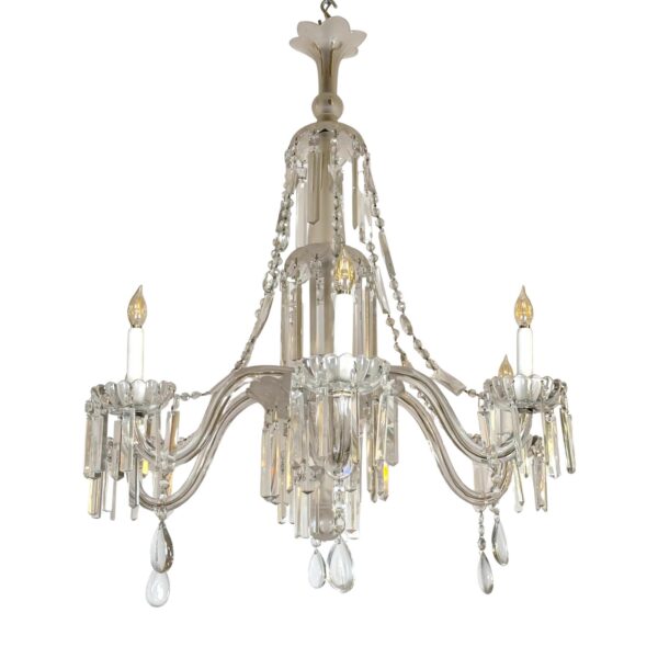 A clear crystal and glass chandelier with six arms and hanging crystal drops.