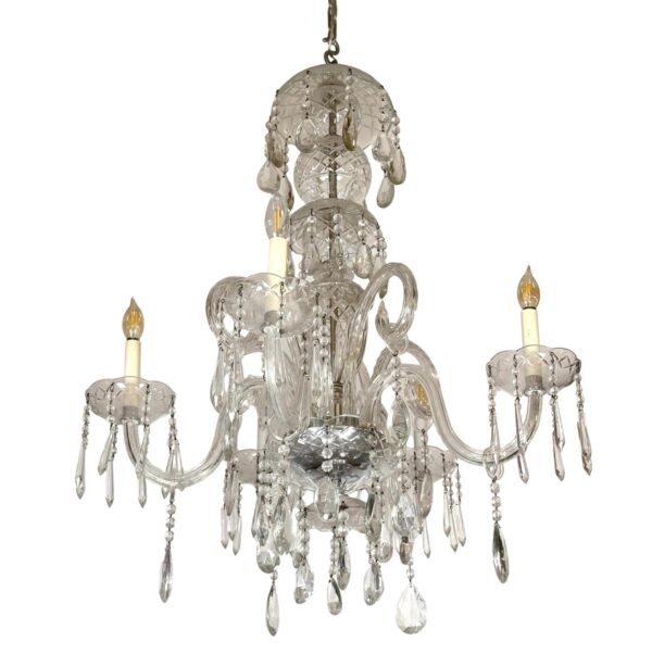 Clear crystal chandelier with five candlestick lights and hanging teardrop pendants.