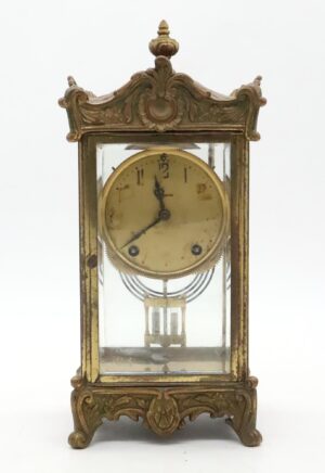 Side view of the regulator clock showcasing intricate gold trim and detailed glasswork, clock hands pointing to 11:27.
