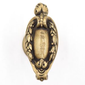 Antique-style oval dummy door knob in French design, shown in close-up with ornate detailing and aged bronze finish.