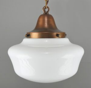 Schoolhouse pendant light with a white milk glass globe and antique brass chain fitter.