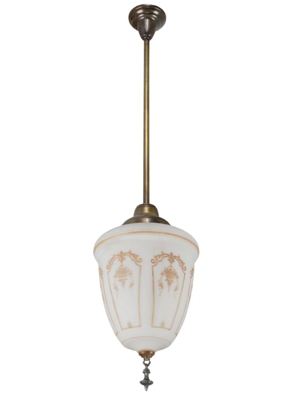 Neoclassical pendant light with a white milk glass shade, antique brass stem, and ornate finial.