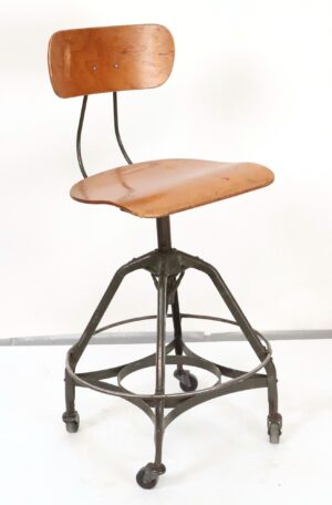 Front view of adjustable vintage industrial stool with wooden seat, backrest, metal frame, and four casters—ideal for studio use.