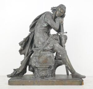 Seated medieval knight in chainmail, head resting on hand, sword in other hand, LE CID on base, by Eugene Laurent, front view.