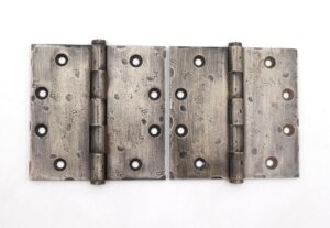 Pair of vintage door hinges shown side by side, each with five knuckles, a hammered nickel finish, and a template hole pattern.