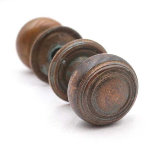 Front view showing the knob’s worn texture and heavy patina against a white background. Side angle highlighting the curved handle and rusty details of the vintage hardware. Close-up of the keyhole plate displaying weathered metal and layered rust patterns. Top-down perspective revealing knob shape, mounting plate, and corroded finish. Detailed shot of the backplate edge, focusing on flaking rust and subtle color variations.
