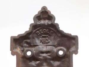 Victorian cast iron pocket door pull with a recessed backplate and two screw holes, shown in close-up with the Reading and Reole markings visible.