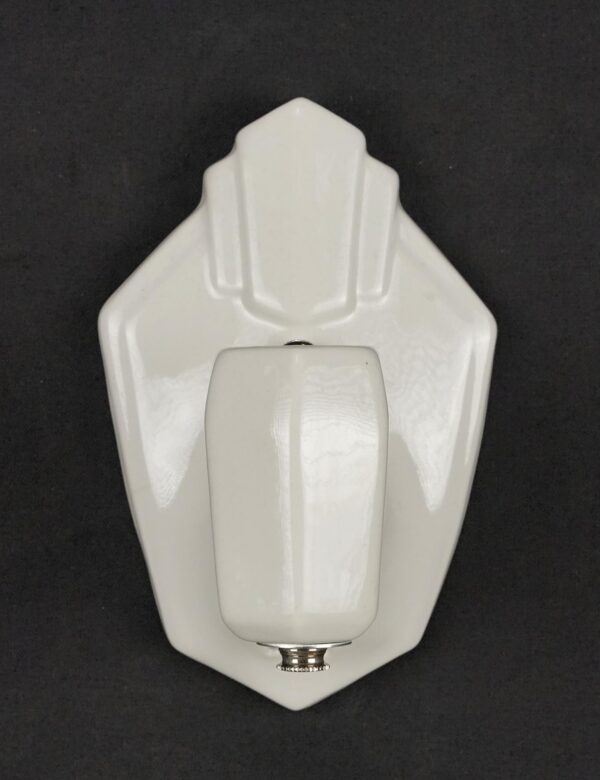 Art Deco white porcelain wall sconce with a geometric backplate and centered shade holder, shown from the front.