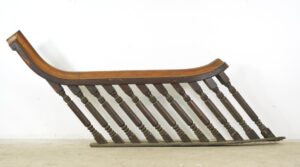 Antique stair railing set with a curved handrail and ten turned spindles, shown in profile in a dark wood tone.